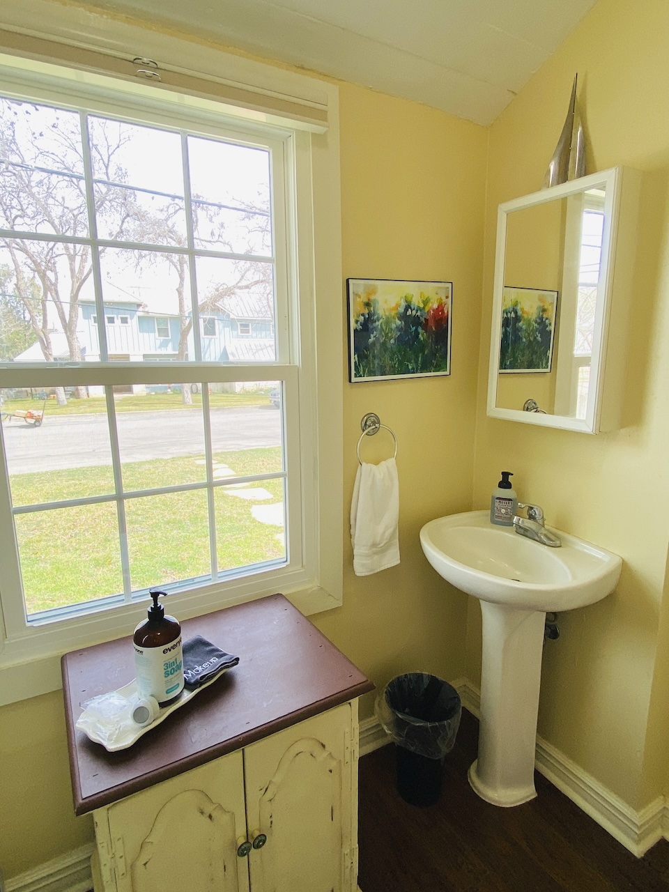 Sink and window in the second bathroom of the New Braunfels Cottage overlooking Comal Avenue